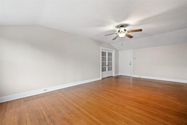 spare room featuring ceiling fan, wood-type flooring, lofted ceiling, and french doors