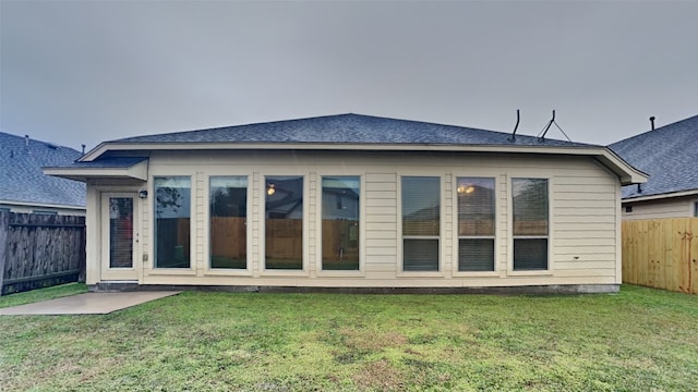 rear view of house with a lawn