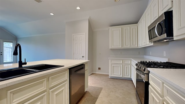 kitchen featuring lofted ceiling, sink, stainless steel appliances, and light tile patterned flooring