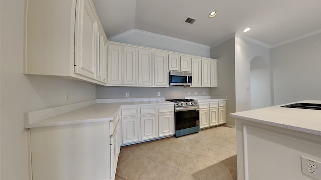 kitchen featuring crown molding, white cabinets, and stainless steel appliances