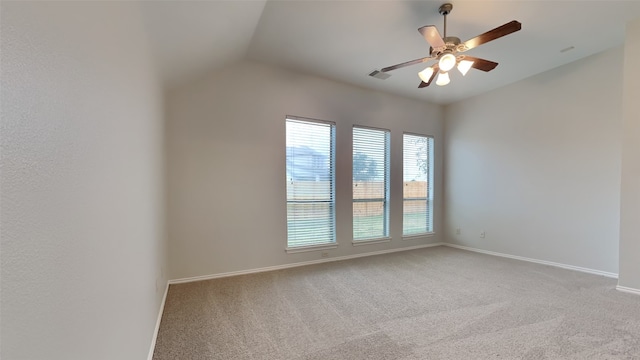 carpeted spare room featuring lofted ceiling and ceiling fan