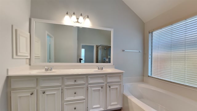 bathroom with vanity, lofted ceiling, and shower with separate bathtub