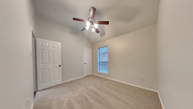 unfurnished room featuring lofted ceiling, light colored carpet, and ceiling fan