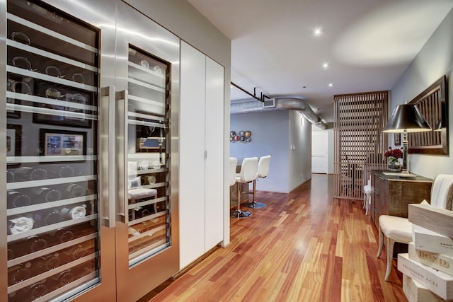 interior space featuring beverage cooler and light hardwood / wood-style flooring