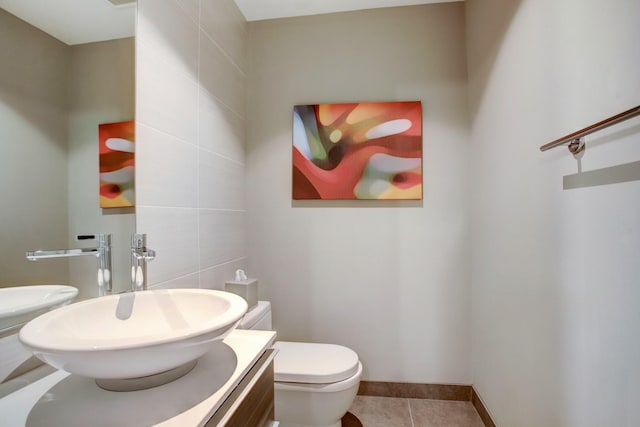 bathroom featuring tile walls, tile patterned floors, vanity, and toilet