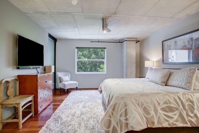 bedroom with ceiling fan and dark wood-type flooring