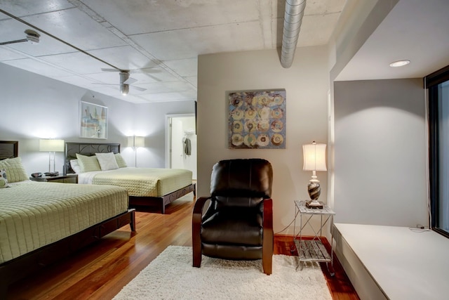 bedroom with ceiling fan and hardwood / wood-style flooring