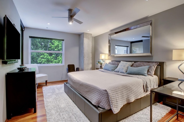 bedroom with ceiling fan and light wood-type flooring