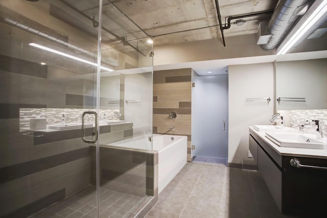 bathroom featuring separate shower and tub, backsplash, and vanity