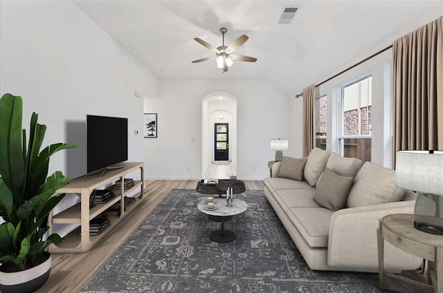 living room with ceiling fan, vaulted ceiling, and hardwood / wood-style flooring