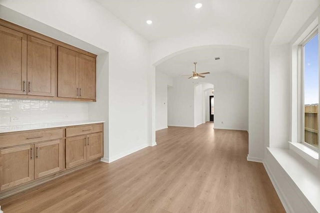 interior space with light wood-type flooring and lofted ceiling