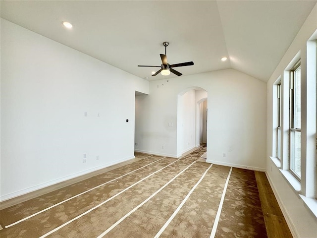 empty room featuring vaulted ceiling and ceiling fan