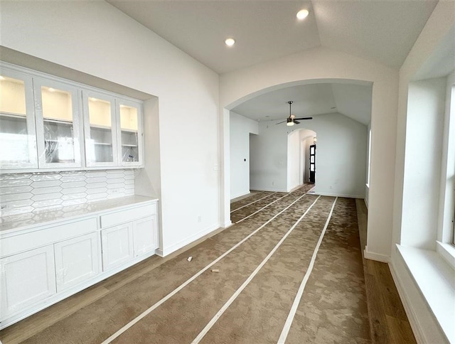 hall featuring lofted ceiling and dark hardwood / wood-style flooring