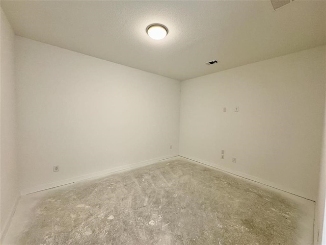 spare room with a textured ceiling