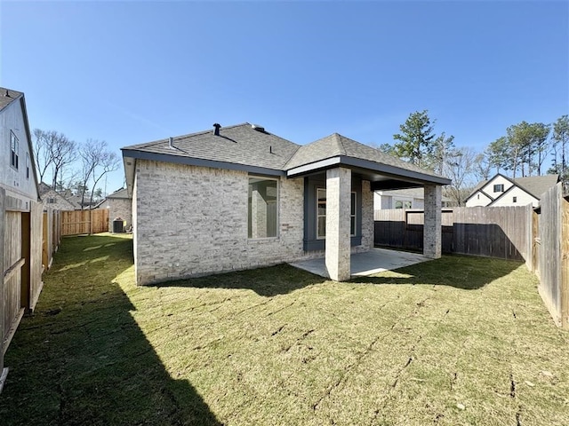 back of property with a patio and a lawn