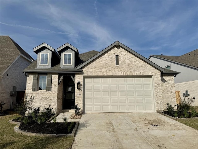 view of front of house featuring stone siding, concrete driveway, and a garage