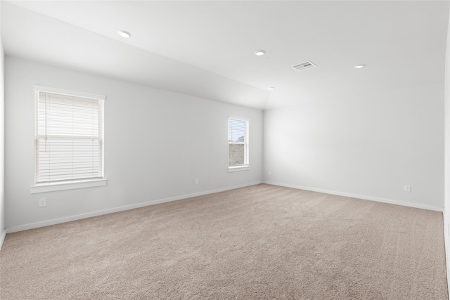 spare room with light colored carpet