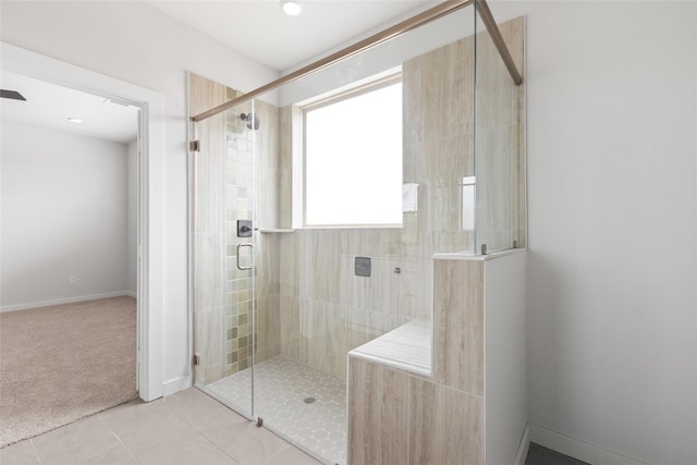 bathroom featuring an enclosed shower and tile patterned floors