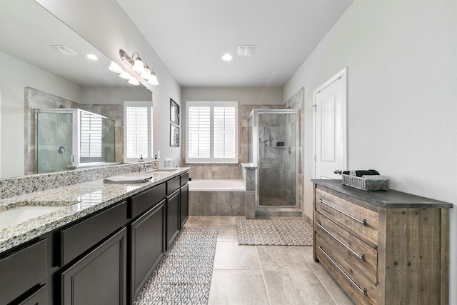 bathroom with independent shower and bath, tile patterned floors, and vanity