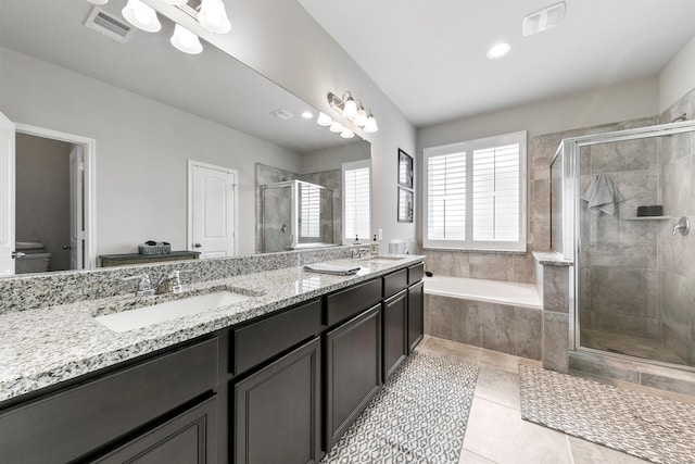 bathroom featuring tile patterned flooring, separate shower and tub, and vanity