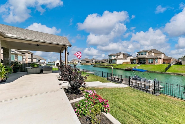 exterior space with a water view, an outdoor hangout area, a lawn, and a patio