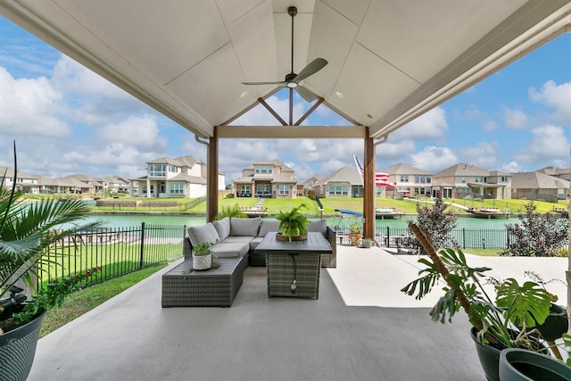 view of patio featuring ceiling fan, outdoor lounge area, and a water view