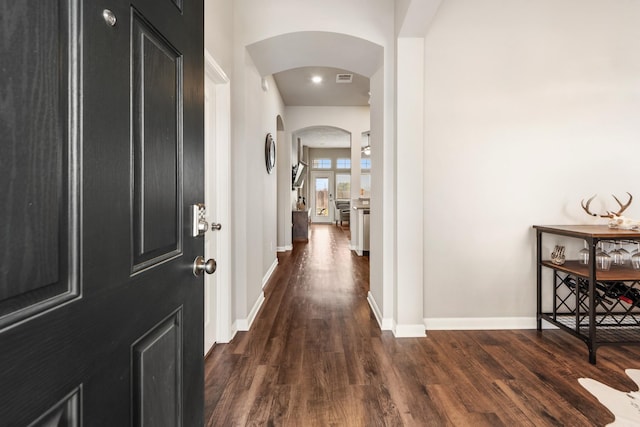 corridor with dark hardwood / wood-style flooring