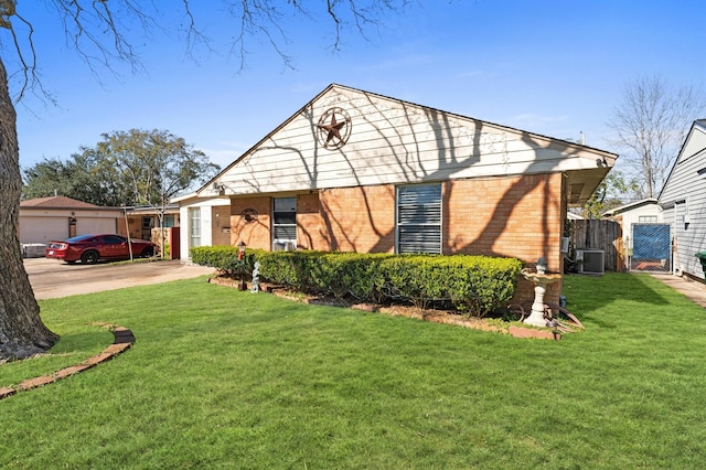 view of front of home with a front lawn, a garage, and central air condition unit