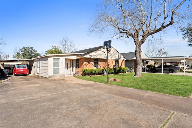 view of front of house with a front yard and a carport