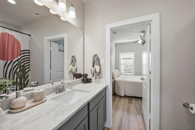 bathroom with ceiling fan, vanity, and hardwood / wood-style flooring