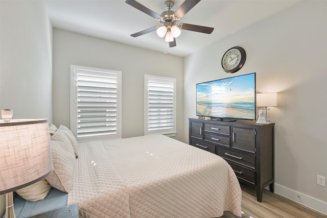 bedroom with ceiling fan and light hardwood / wood-style floors