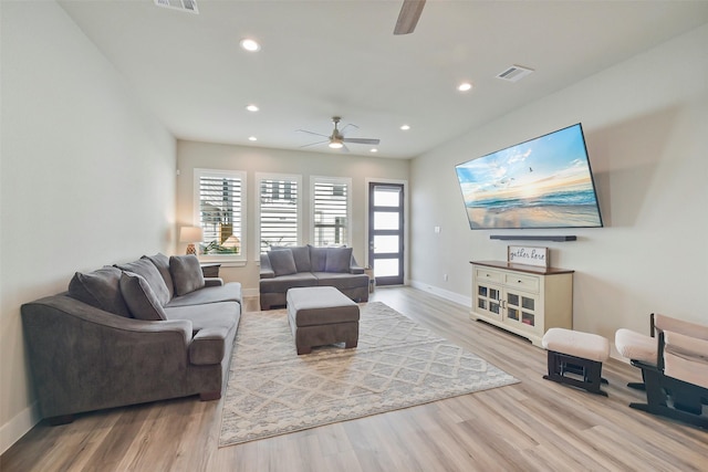 living room featuring ceiling fan and light hardwood / wood-style flooring