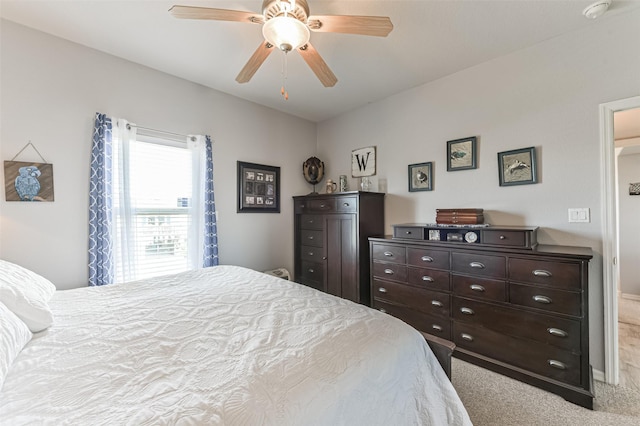 bedroom featuring light carpet and ceiling fan