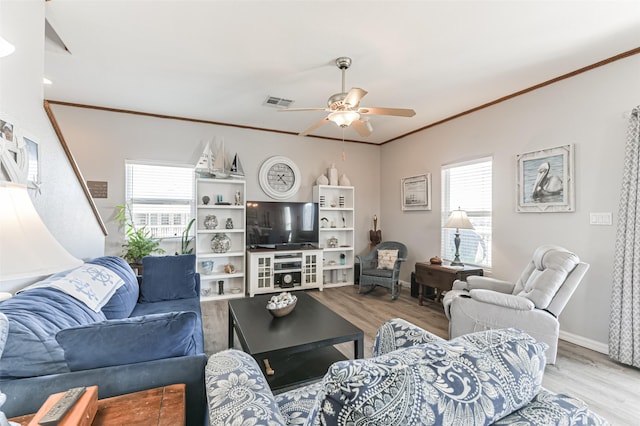 living room featuring light wood-type flooring, ceiling fan, and a healthy amount of sunlight