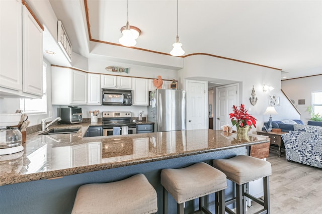 kitchen featuring pendant lighting, kitchen peninsula, sink, stainless steel appliances, and white cabinets