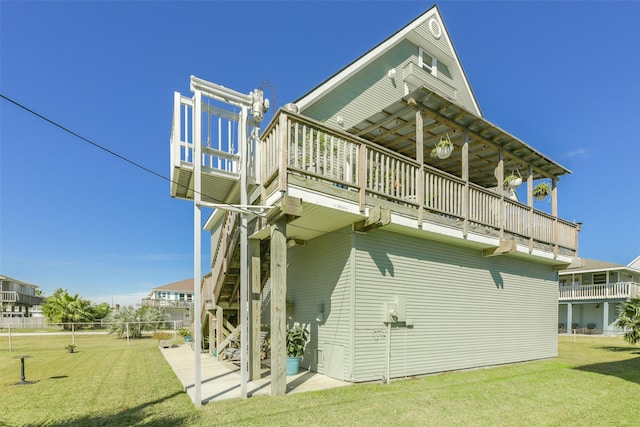 back of house featuring a patio and a yard