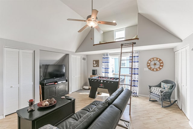 living room with light wood-type flooring, ceiling fan, and vaulted ceiling