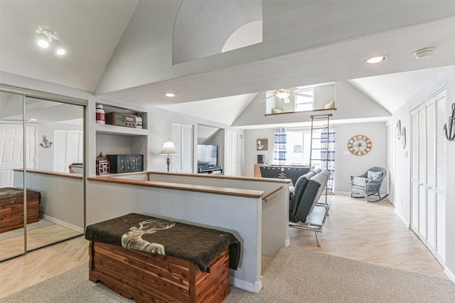 kitchen featuring ceiling fan, high vaulted ceiling, built in features, and light hardwood / wood-style flooring