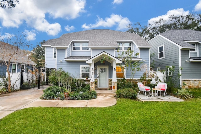 view of front facade featuring a front lawn and a patio