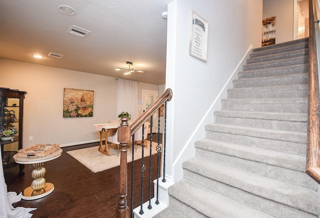 stairway with hardwood / wood-style floors