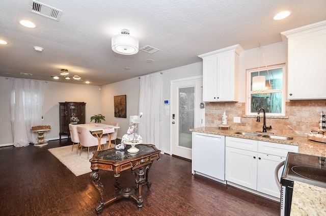 kitchen featuring white cabinetry, dark hardwood / wood-style floors, white dishwasher, hanging light fixtures, and sink