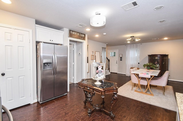 kitchen featuring stainless steel refrigerator with ice dispenser, a textured ceiling, white cabinets, and dark hardwood / wood-style floors