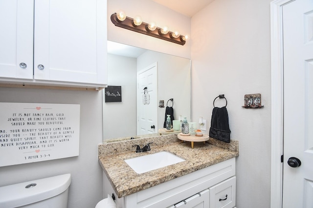 bathroom featuring toilet and vanity