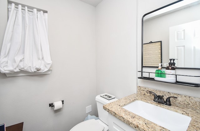 bathroom featuring toilet and vanity