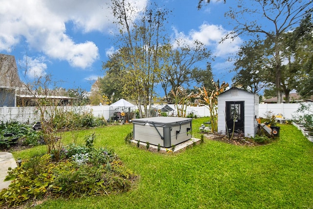 view of yard featuring a storage shed and a hot tub