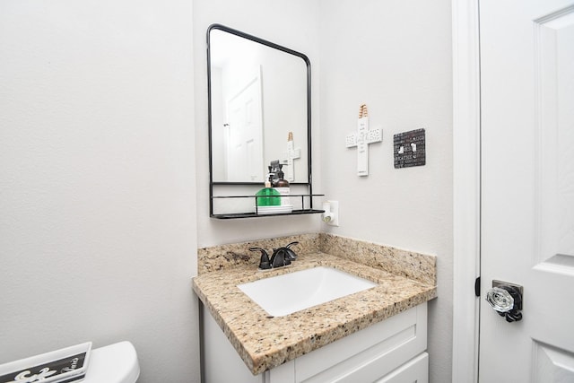 bathroom featuring toilet and vanity