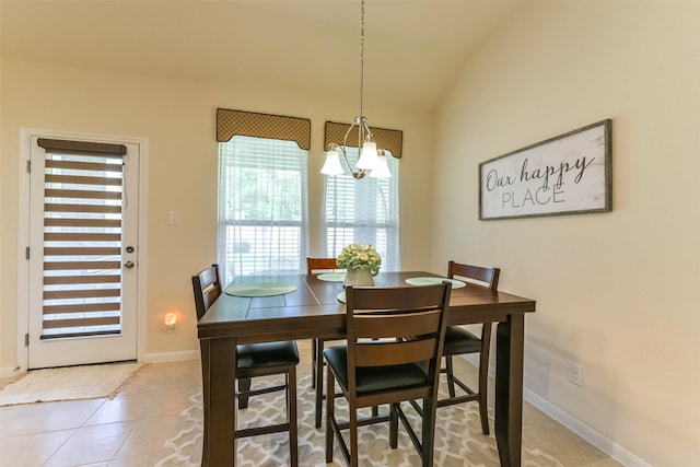 tiled dining space featuring lofted ceiling and a notable chandelier