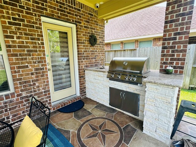 view of patio featuring area for grilling and sink