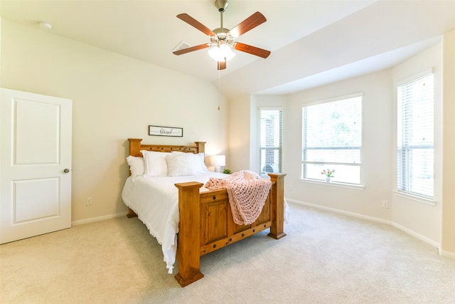 bedroom featuring ceiling fan, light carpet, and vaulted ceiling