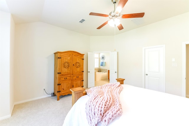 bedroom featuring ceiling fan, light colored carpet, connected bathroom, and lofted ceiling